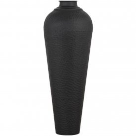 Tall 80cm charcoal black metal vase featuring an elongated column profile with a dimpled hammered texture surface.