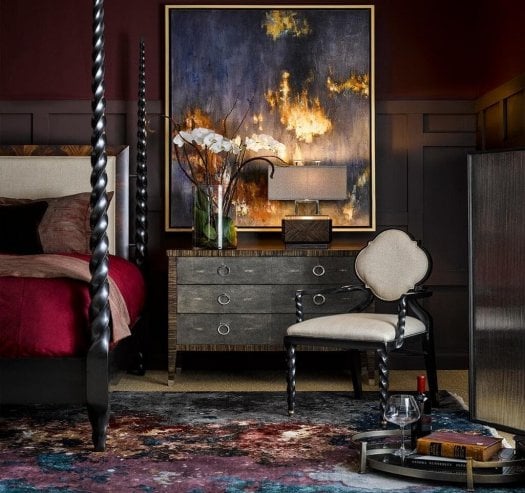 Luxury bedroom furniture by Jonathan Charles featuring a four-poster bed, chest of drawers and upholstered bedroom chair in an elegant designer bedroom setting.