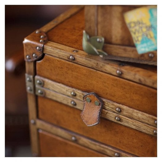 Luxury storage solutions at Swanky Interiors featuring a vintage-style wooden storage trunk with leather straps and metal detailing.