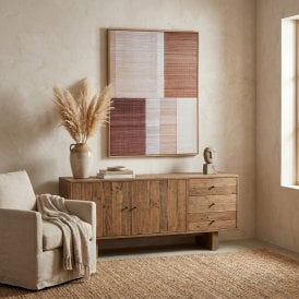 Umbora hand-painted abstract framed canvas wall art displayed above a rustic wooden sideboard in a neutral living room.